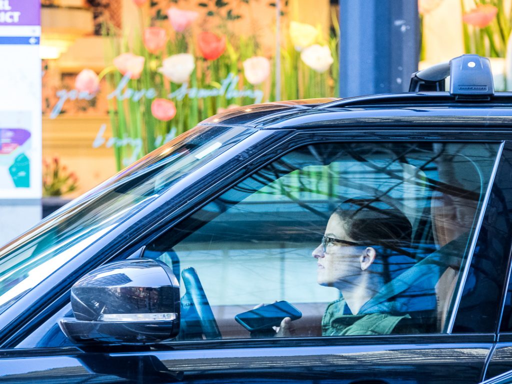 Woman driving a car while talking into a cell phone