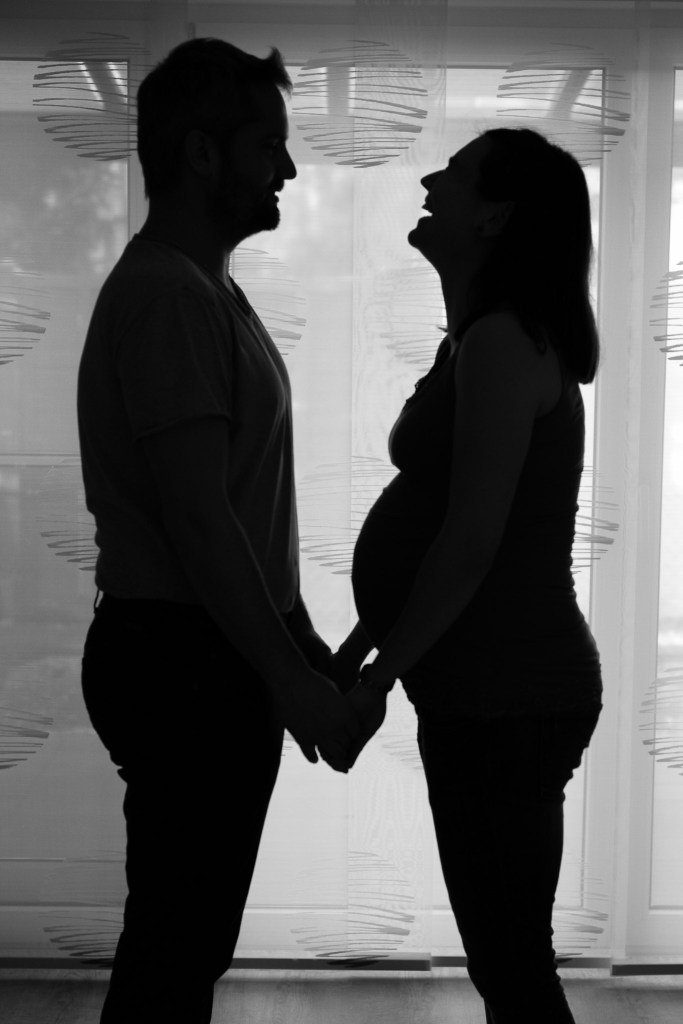 Silhouettes of pregnant couple