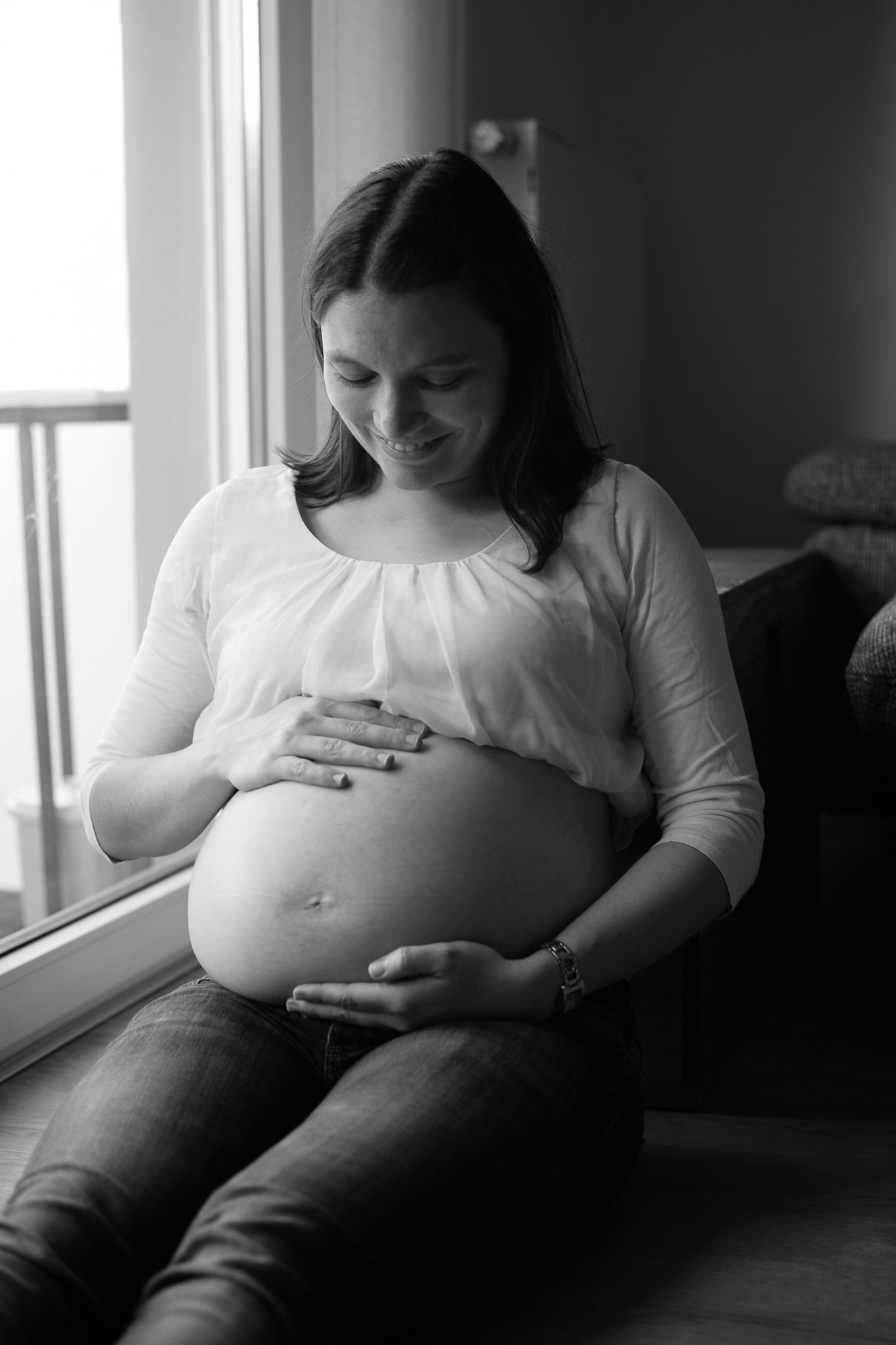 Pregnant girl looking at her belly