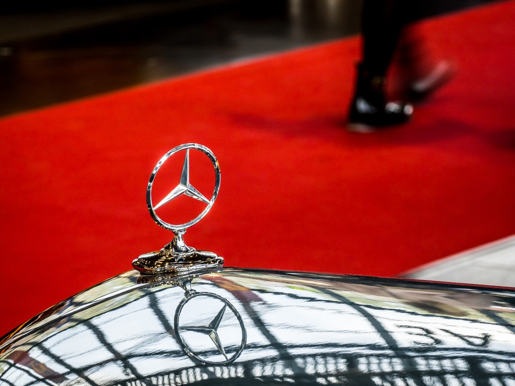 Mercedes Benz Emblem in front of a red carpet