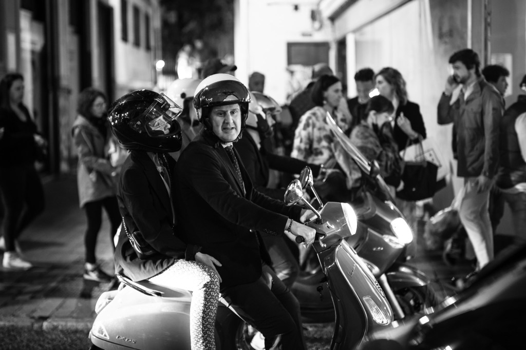 Man and girl on a scooter during a night in Sevilla