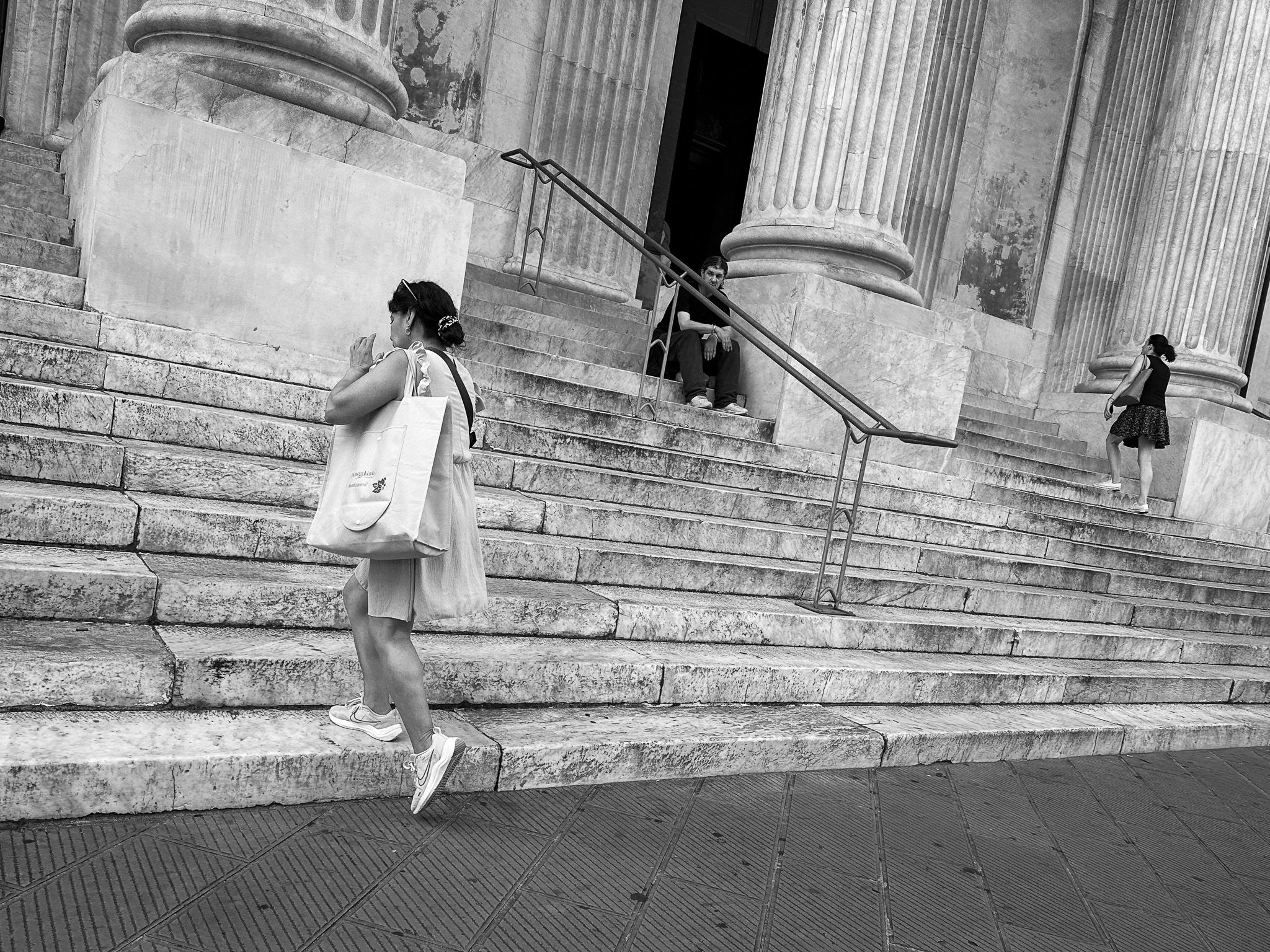 Late - Two ladies in dresses running up the marble stairs to a church