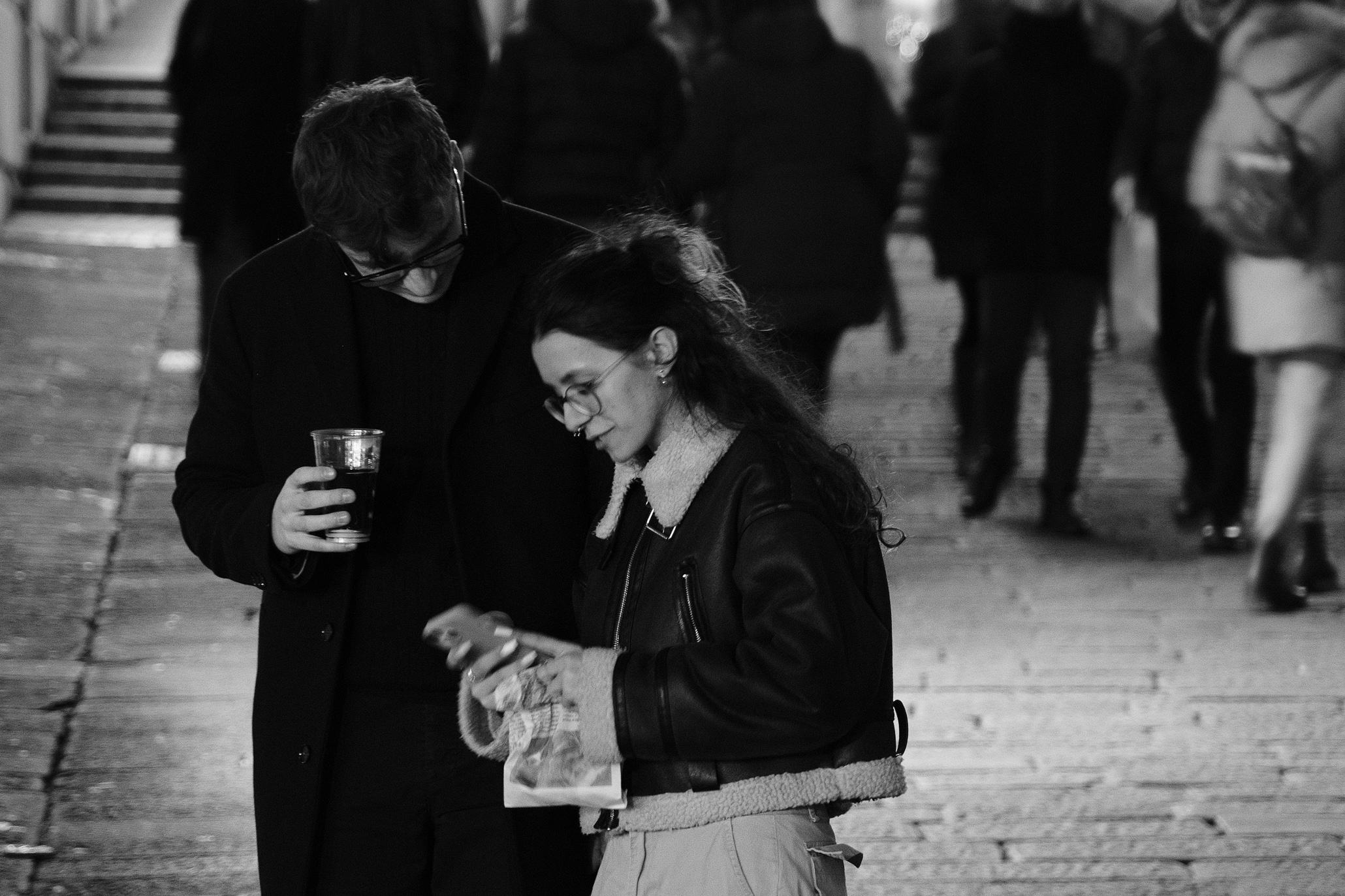 Street Photograph of a boy and girl putting their heads together