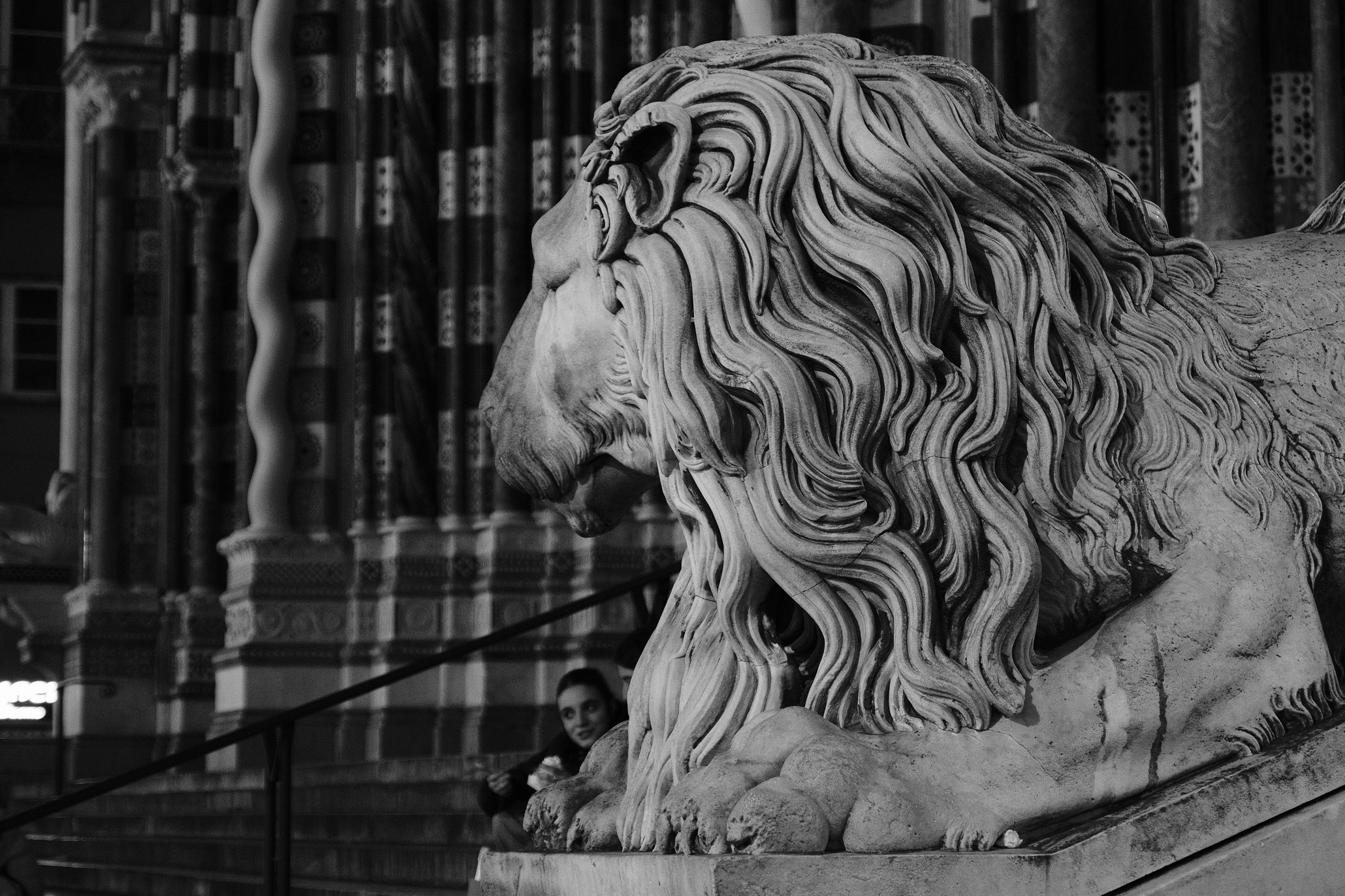 People sitting under the Lions head of San Lorenzo in Genoa's Centro Storico