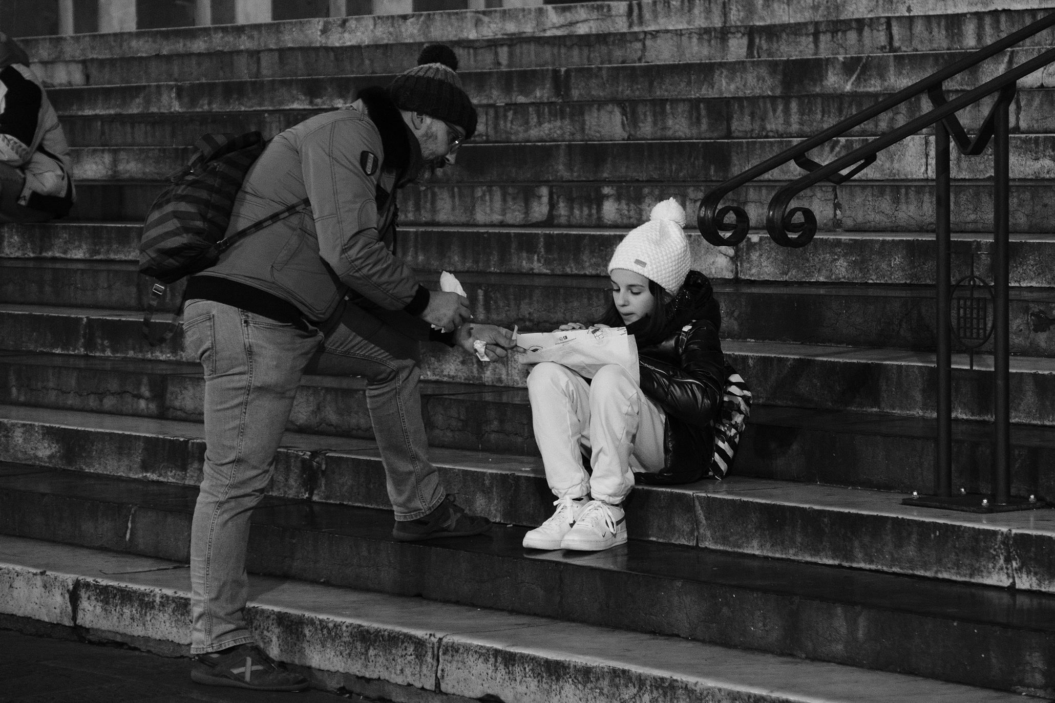 People eating on the stairs of San Lorenzo in Genoa's Centro Storico