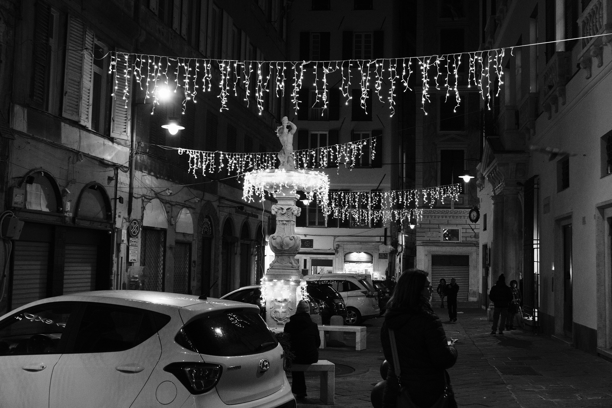 People and cars in Genova's Centro Storico