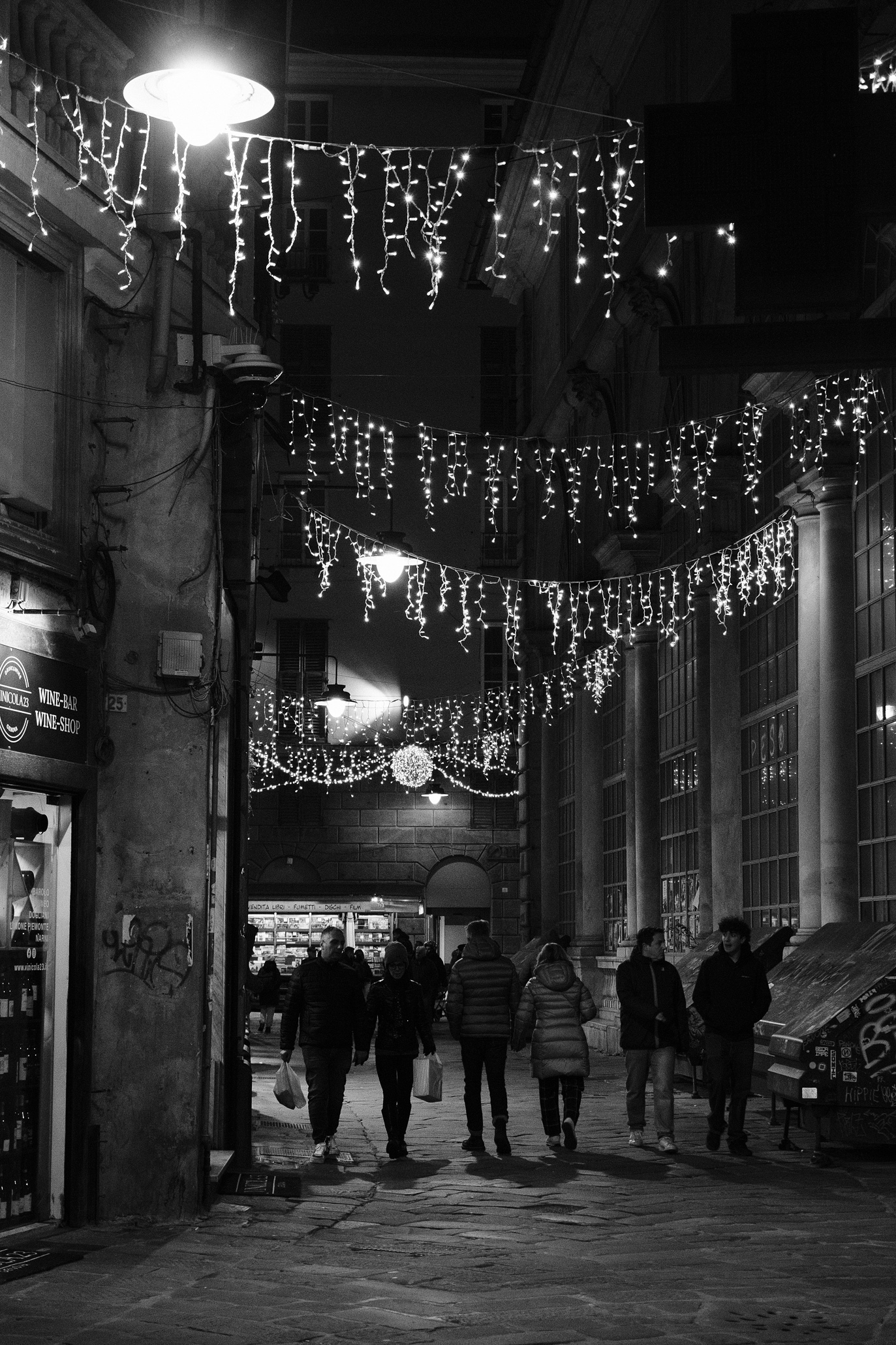 People walking under Christmas decoration in Genoa's Centro Storico