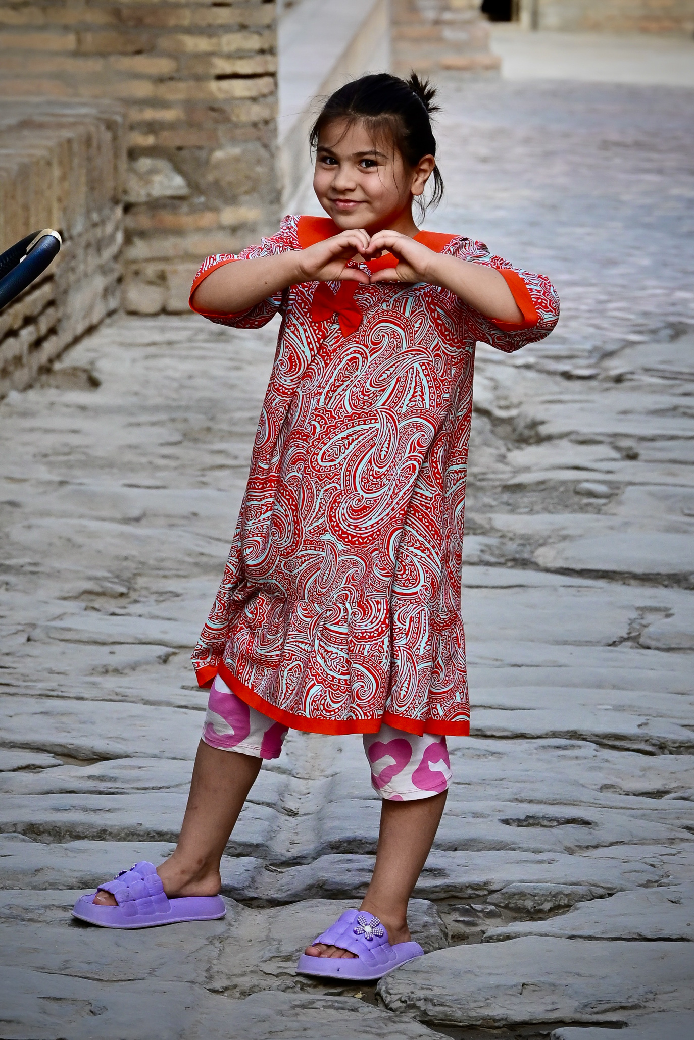 Girl in Khiva Uzbekistan showing me a heart with her hands