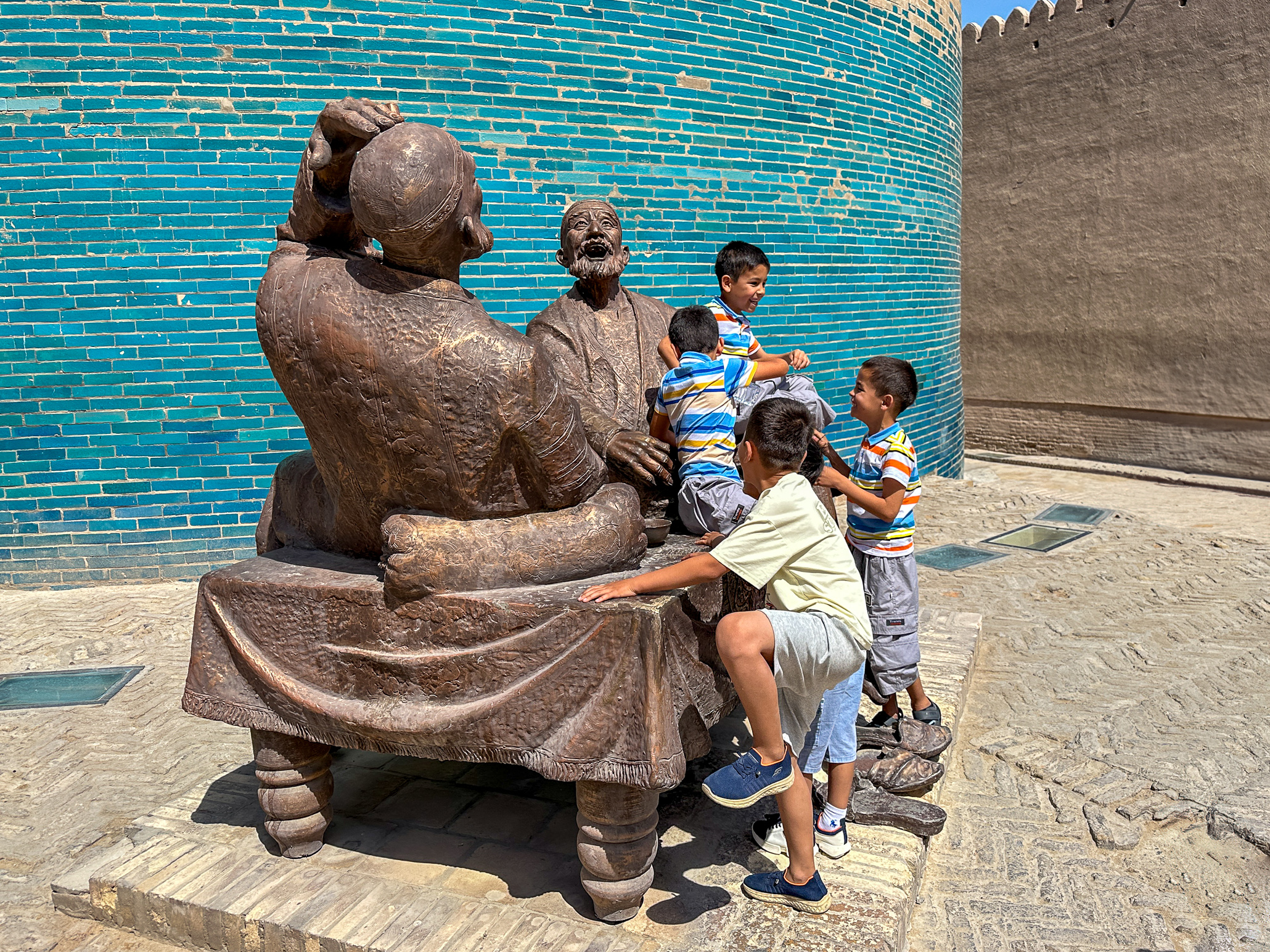 Little Boys climbing a statue in Chiwa Uzbekistan
