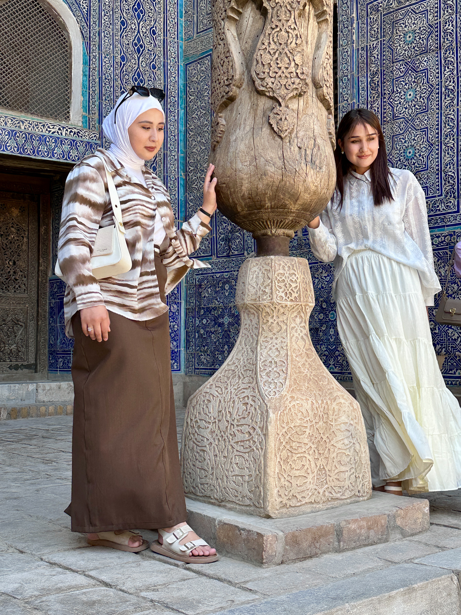 Two Uzbek girls, one with a vail, one with western clothes
