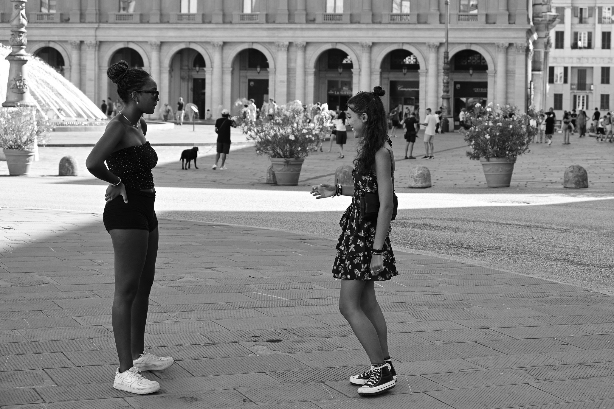 Two girls talking in Piazza de Ferrari in Genoa
