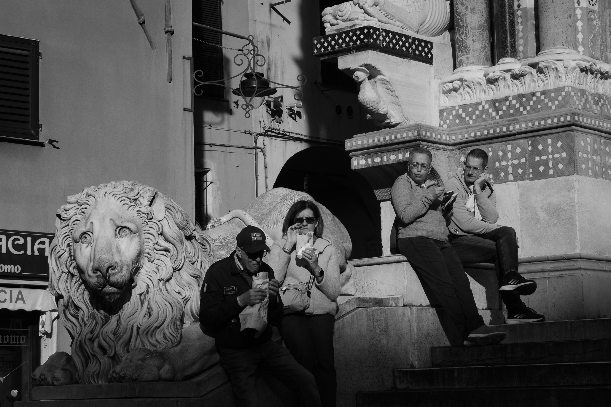 People eating on the steps of San Lorenzo Cathedral in Genoa