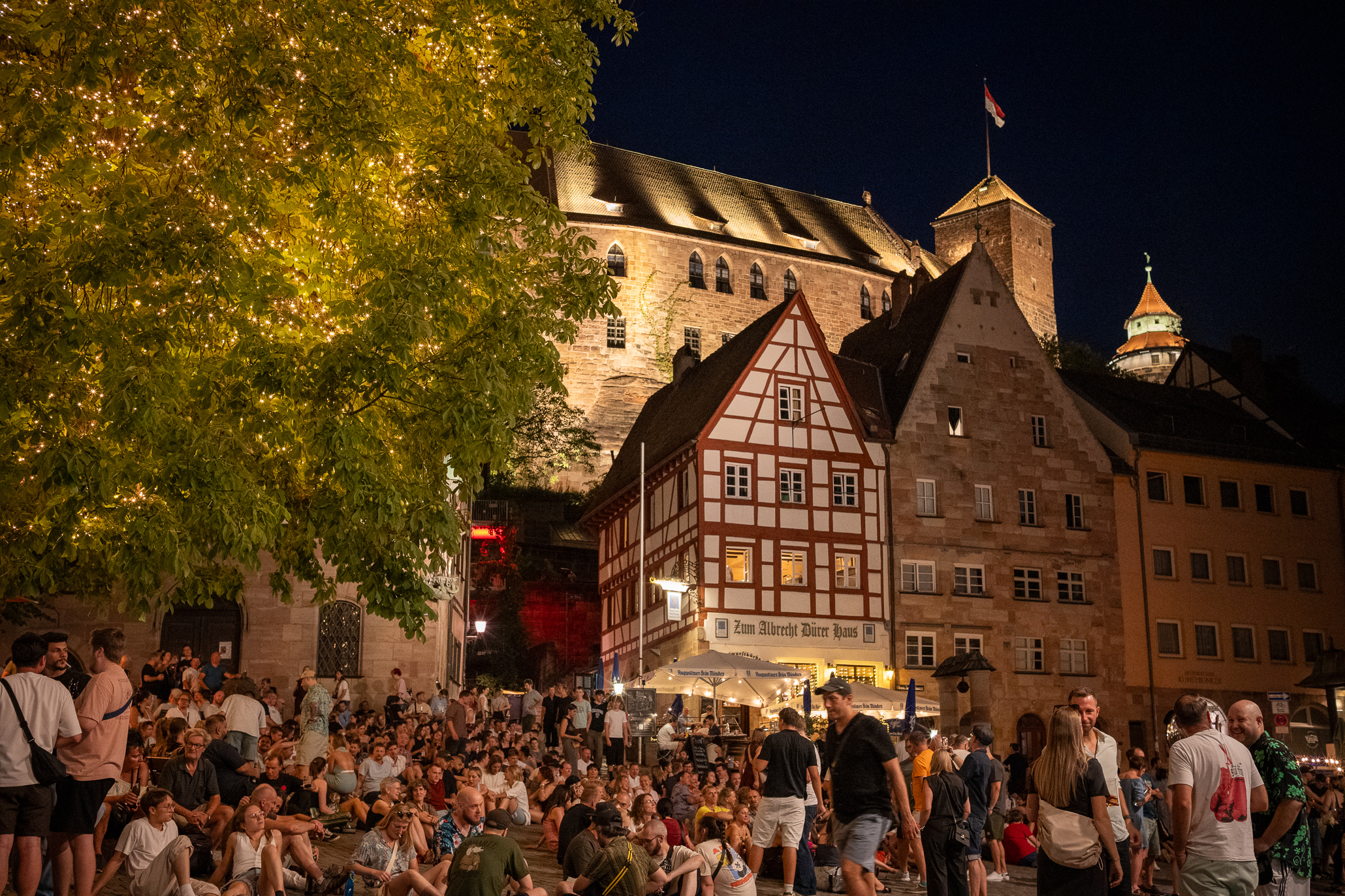 Evening crowd at the Tiergärtnertorplatz below the Imperial Castle in Nuremberg, Germany